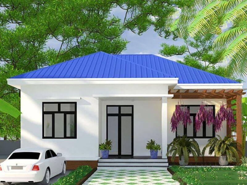 Nhà một tầng hiện đại với mái màu xanh, vườn cây xanh mát, ô tô trắng đỗ bên cạnh.