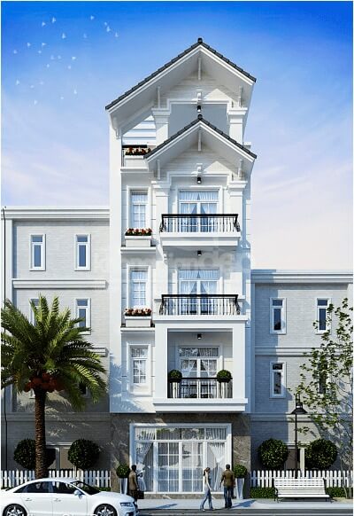 Tòa nhà trắng hiện đại với các ban công, cây cọ phía trước và bầu trời xanh.