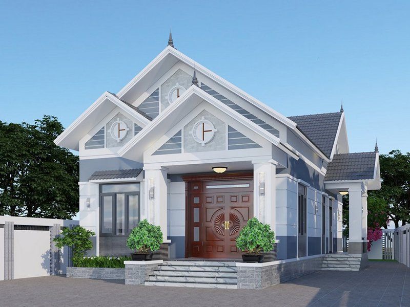 Nhà mái thái hiện đại 1 tầng, mặt tiền rộng, cửa gỗ lớn, màu sắc trung tính, cây xanh trang trí trước nhà.