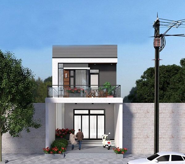 Nhà phố hai tầng hiện đại với cửa kính lớn và ban công, cây xanh phía trước, bầu trời xanh.