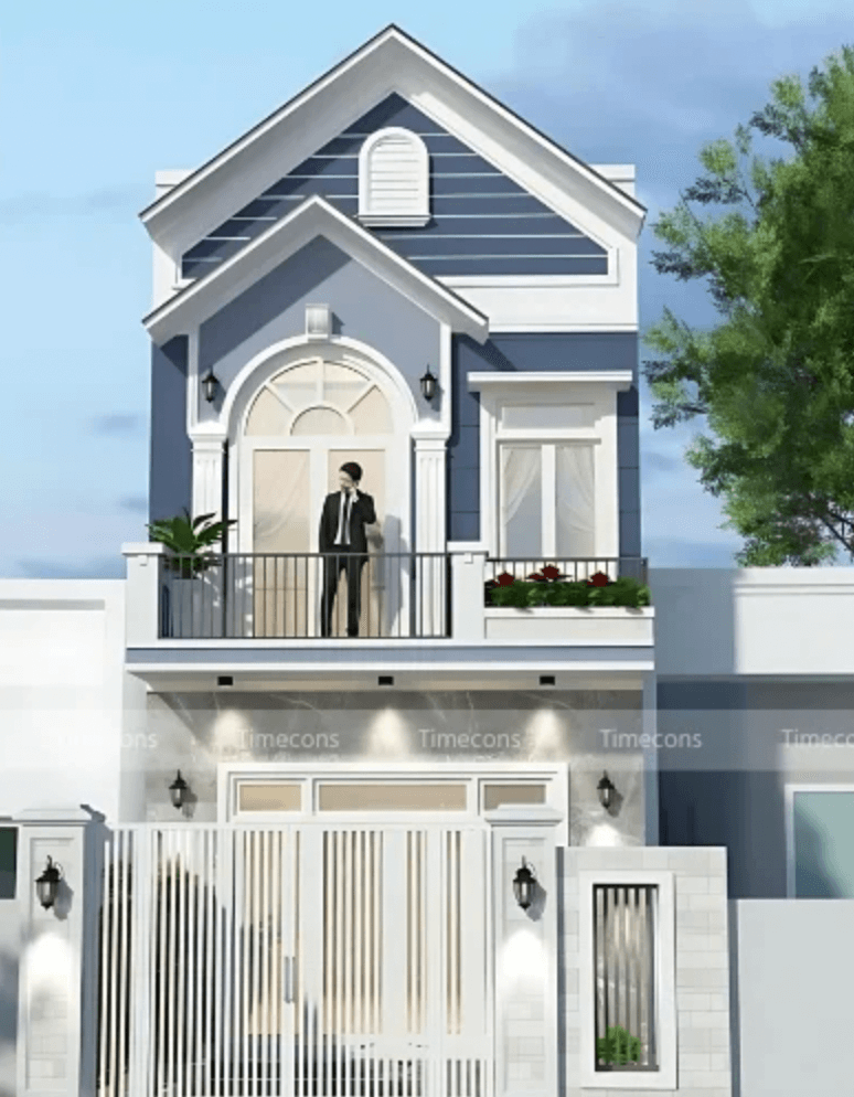 Ngôi nhà hai tầng với thiết kế hiện đại và người đàn ông đứng trên ban công, cây xanh xung quanh.