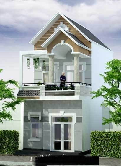 Ngôi nhà hai tầng hiện đại với ban công và cửa kính lớn, có cây xanh bao quanh, trời nắng đẹp.