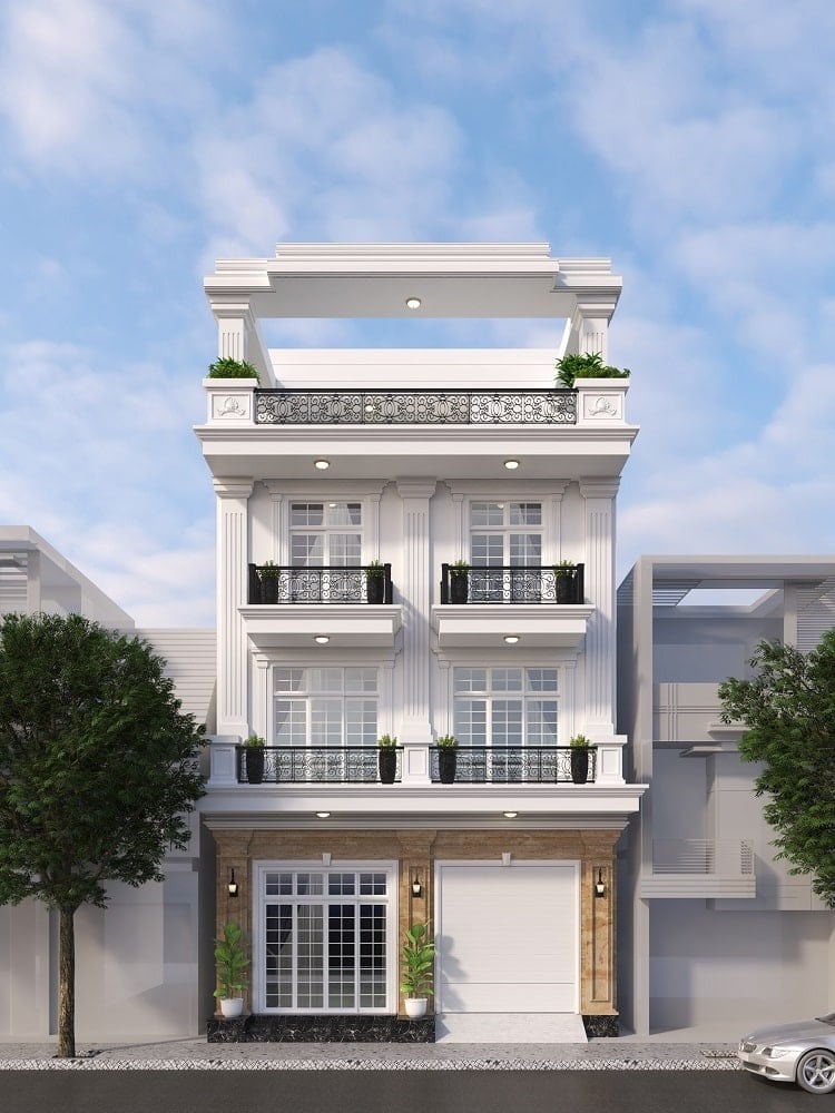 Mặt tiền nhà phố hiện đại ba tầng với lan can hoa văn và cửa kính lớn, cây xanh trang trí trước nhà.