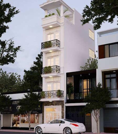 Nhà phố hiện đại nhiều tầng với ban công và cây xanh, xe hơi trắng đỗ phía trước, cây xanh xung quanh.