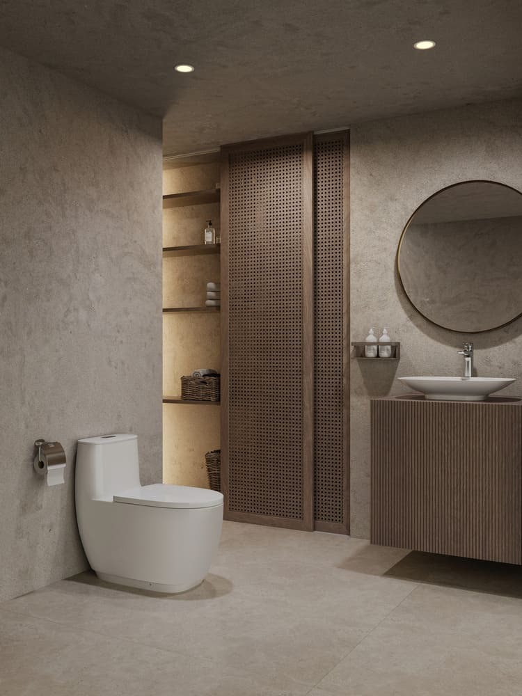 Phòng tắm hiện đại với bồn cầu trắng và gương tròn lớn, tường và sàn màu be nhạt, thiết kế tối giản.