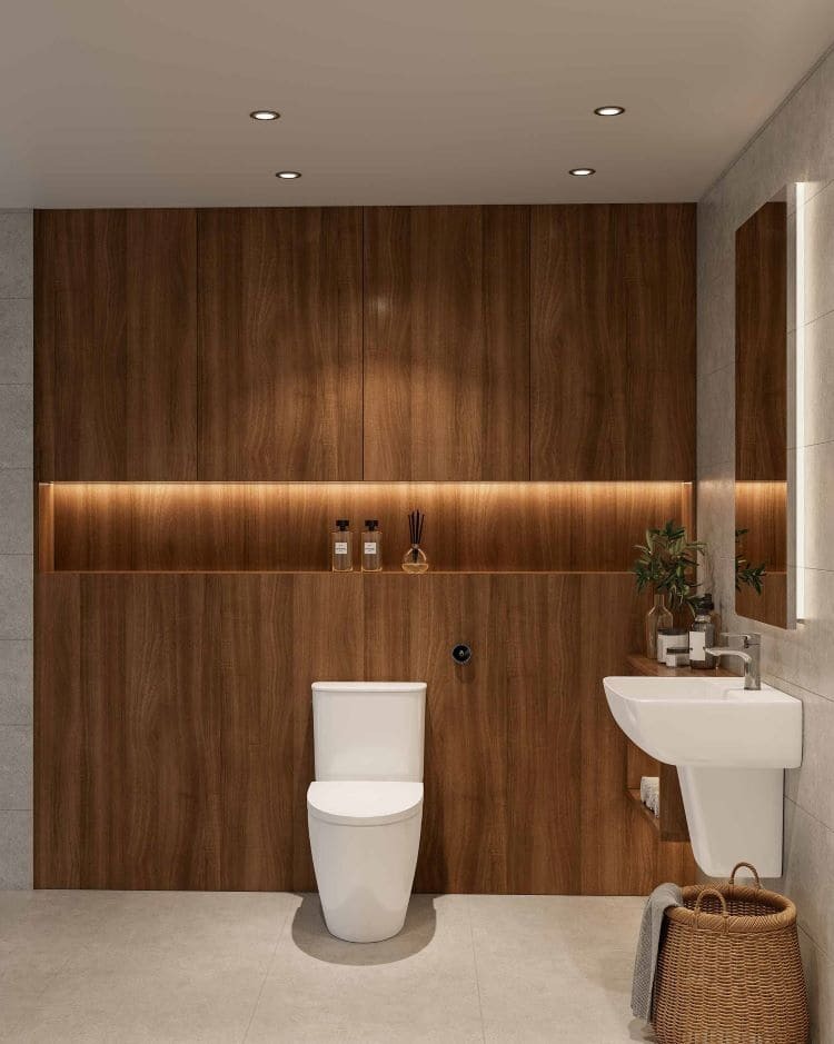 Phòng tắm hiện đại với bồn cầu, bồn rửa trắng và tường ốp gỗ sang trọng, ánh sáng ấm áp.