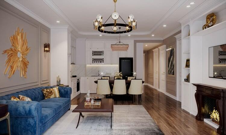 Phòng khách và bếp hiện đại với sofa xanh, bàn ăn sang trọng, đèn chùm và sàn gỗ nâu ấm áp.