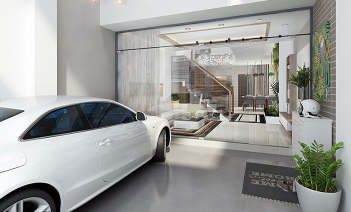 Xe ô tô trắng đỗ trước nhà, nội thất hiện đại và sang trọng với thiết kế mở và cầu thang gỗ.