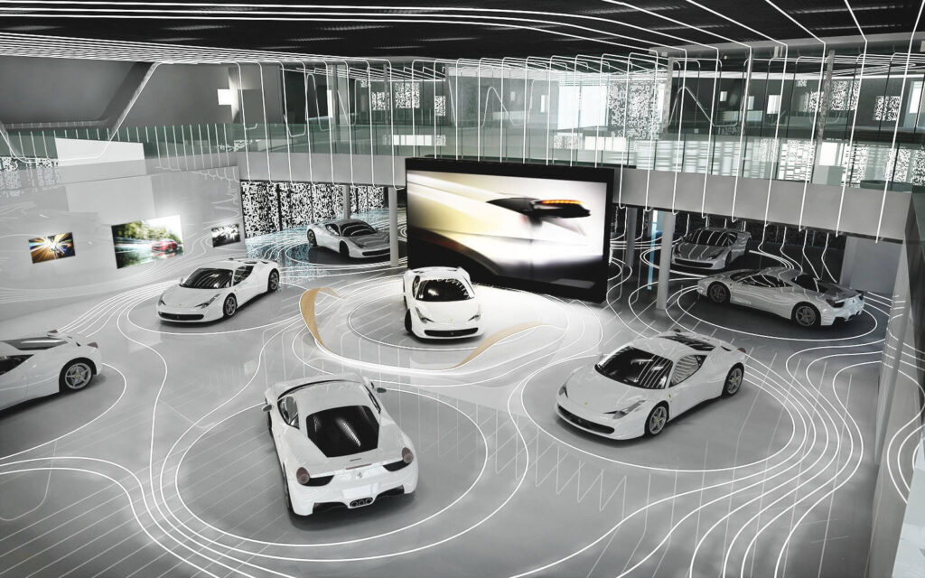Phòng trưng bày xe hơi sang trọng với các mẫu xe thể thao trắng, thiết kế hiện đại và ánh sáng nổi bật.