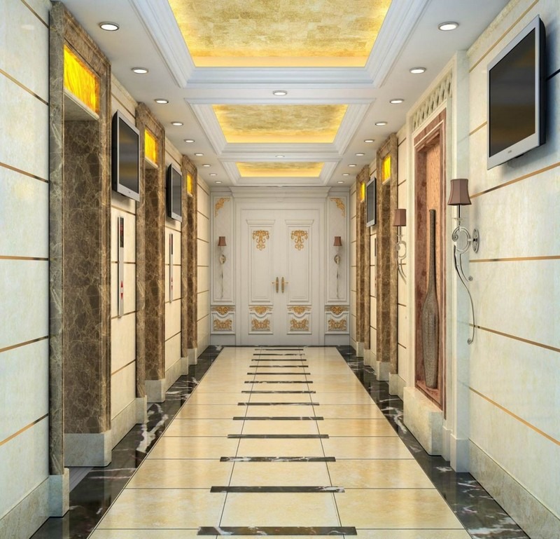 Hành lang sang trọng với trần mạ vàng, tường ốp đá cẩm thạch và cửa ra vào trang trí hoa văn tinh tế.