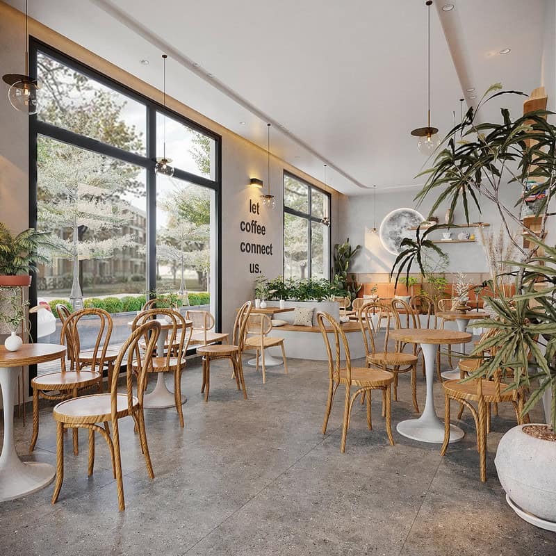 Quán cà phê hiện đại với nội thất gỗ và cây xanh, ánh sáng tự nhiên tạo không gian thoải mái, thư giãn.