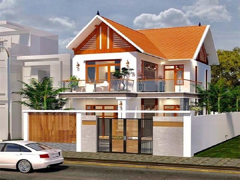 Ngôi nhà hai tầng hiện đại với mái ngói đỏ, ban công và sân vườn trong khu dân cư.