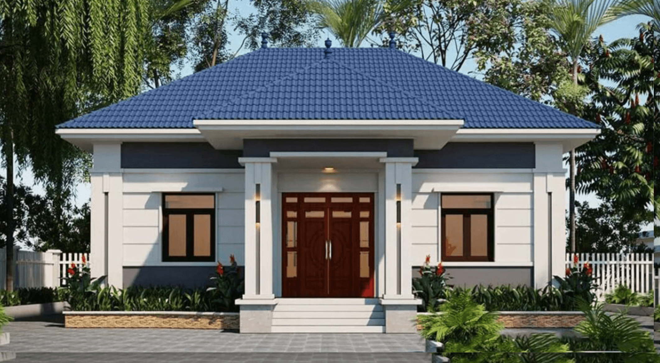 Ngôi nhà mái thái một tầng với mái màu xanh, tường trắng, cửa gỗ đỏ, xung quanh là cây cối xanh tươi.