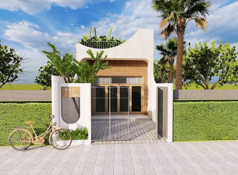 Nhà hiện đại với sân vườn nhỏ, cổng kim loại và xe đạp bên cạnh, nền trời xanh.
