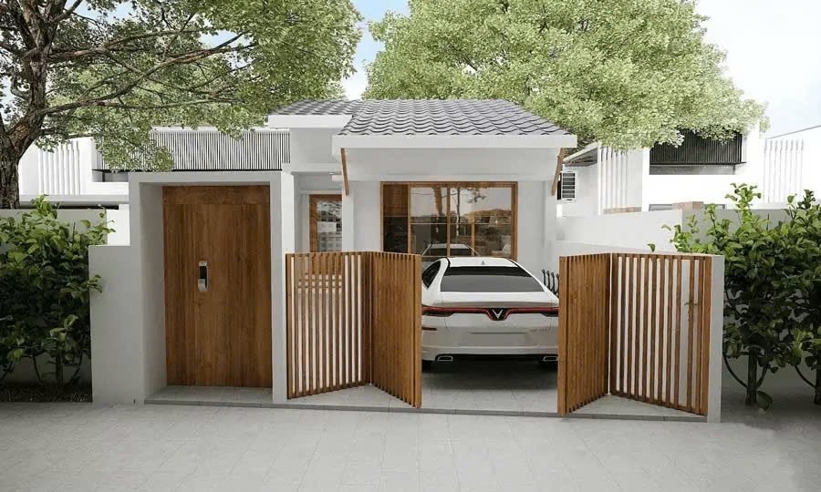 Nhà nhỏ hiện đại với cửa gỗ, xe ô tô đỗ trước sân, có cây xanh và hàng rào trang trí.