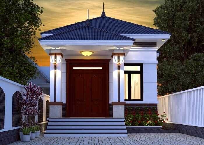 Nhà mái thái nhỏ gọn với cửa gỗ lớn, phong cách hiện đại, ánh sáng đèn vàng tạo không gian ấm cúng và sang trọng.