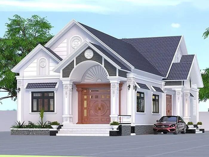 Nhà cấp 4 hiện đại, mái ngói xanh, cửa gỗ sang trọng và ô tô đỗ trước sân, cây xanh tạo không gian thoáng đãng.