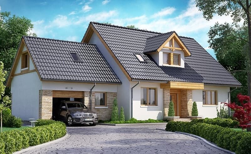 Nhà hai tầng màu trắng với mái ngói xanh, gara xe, cây cối xung quanh, tạo không gian sống hiện đại và thoải mái.