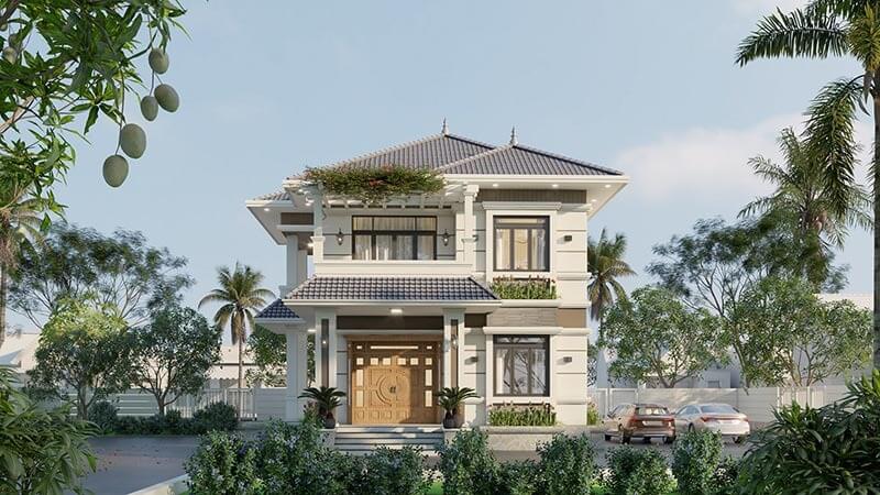 Biệt thự hai tầng với mái ngói xanh, sân vườn cùng cây cối xung quanh, bầu trời trong xanh ngập nắng.