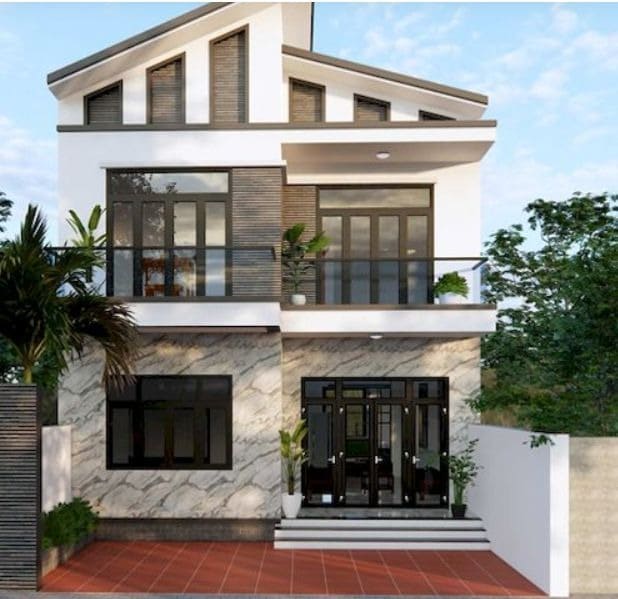 Nhà 2 tầng hiện đại với cửa kính lớn và sân rộng, xung quanh cây xanh, phù hợp làm gia đình.