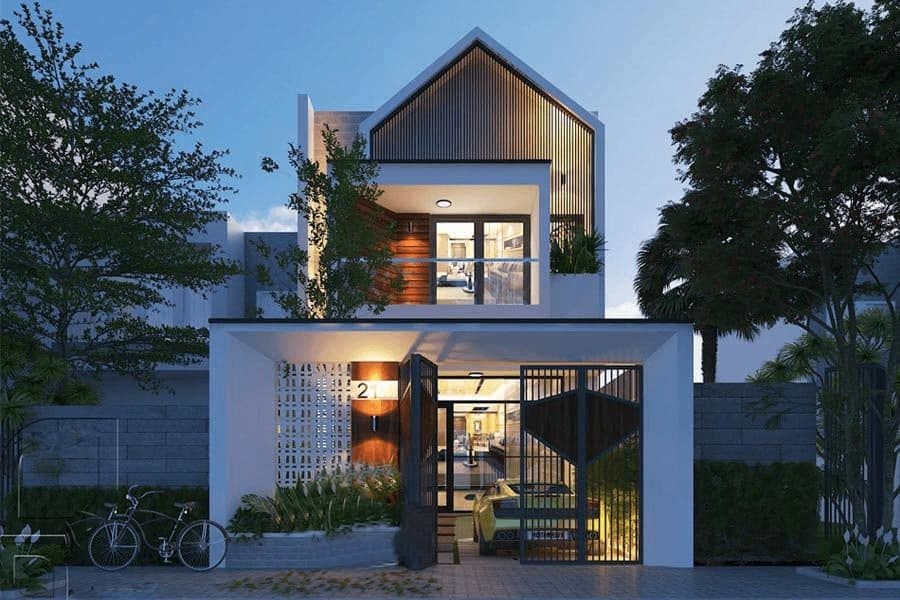Ngôi nhà hiện đại hai tầng với thiết kế mái độc đáo, cây xanh phía trước và ánh sáng tối giản.
