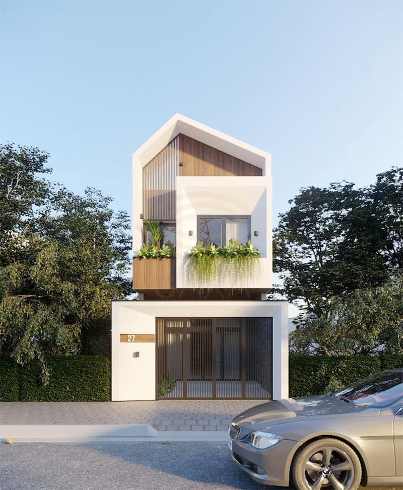 nha-may-lech-2-tang-20 Ngôi nhà hiện đại với thiết kế mái nhọn, ban công cây xanh, mặt tiền sáng sủa. Xe ô tô đỗ phía trước.