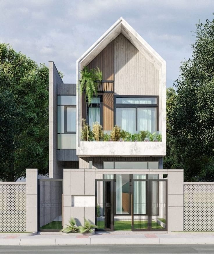 Ngôi nhà hai tầng hiện đại với thiết kế mặt tiền độc đáo, cây xanh trang trí phía trước, tạo không gian sống thoải mái.