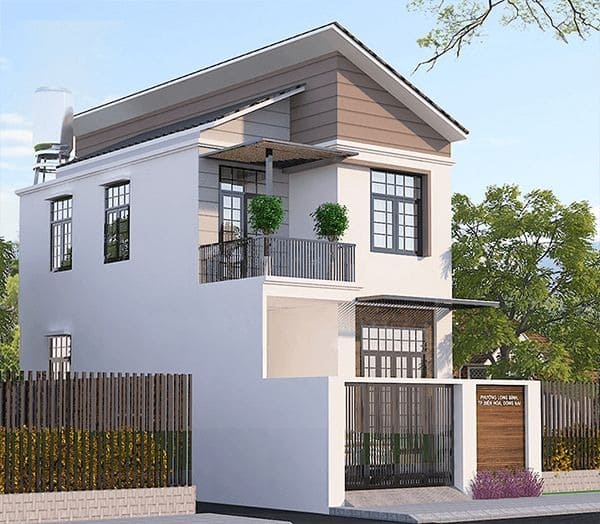Nhà 2 tầng hiện đại với ban công xanh, mái dốc, xung quanh cây cối, hàng rào gỗ.