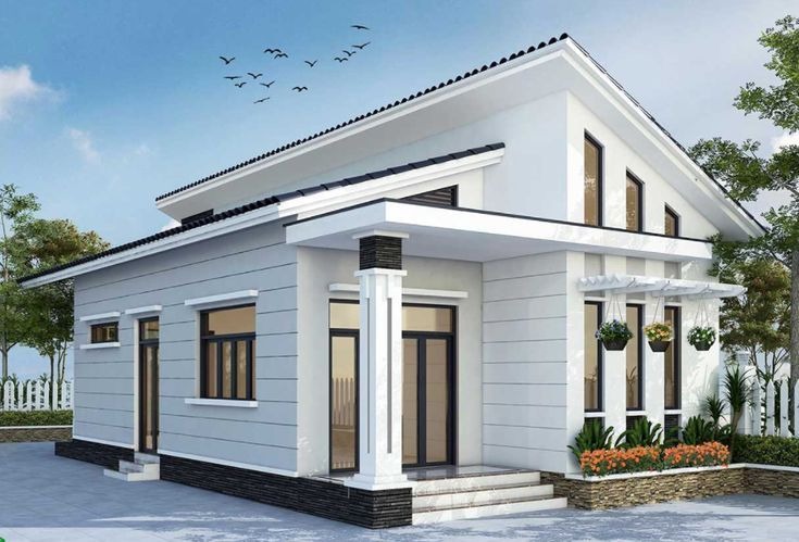 nha-may-lech-2-tangg Ngôi nhà một tầng hiện đại với mái dốc, cửa kính lớn, sân vườn xung quanh và cây xanh trang trí.