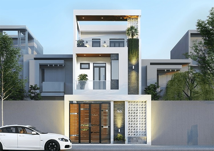 Nhà hiện đại 3 tầng với thiết kế tối giản, cửa kính lớn, trang trí cây xanh phía trước, xe hơi trắng đỗ bên đường.