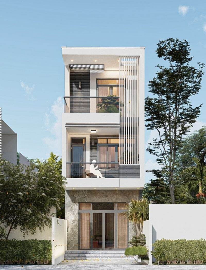 Nhà 3 tầng hiện đại với ban công rộng thoáng và cây xanh trước cổng, kiến trúc tối giản.