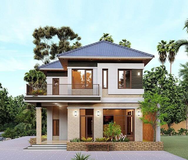 Nhà 2 tầng hiện đại với mái ngói xanh, cửa kính rộng, xung quanh là cây xanh và không gian thoáng đãng.