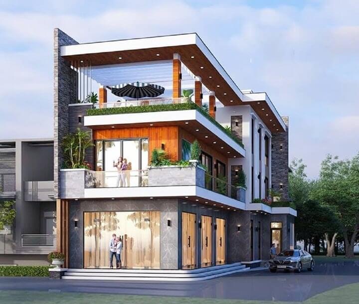 Ngôi nhà hiện đại ba tầng với ban công rộng và cây xanh trang trí, nằm giữa khu dân cư xanh mát.