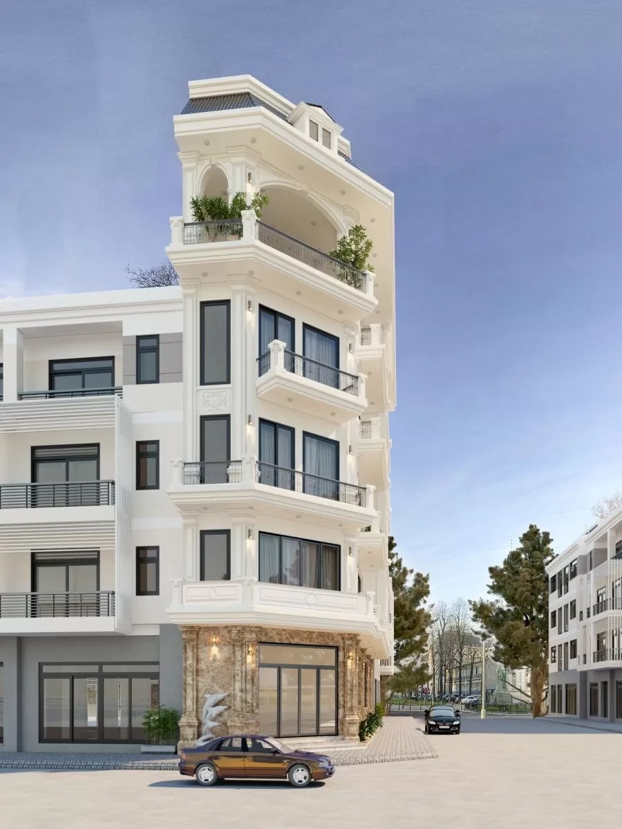 Tòa nhà sang trọng kiểu cổ điển với ban công và cây xanh, phía trước có ô tô màu nâu.