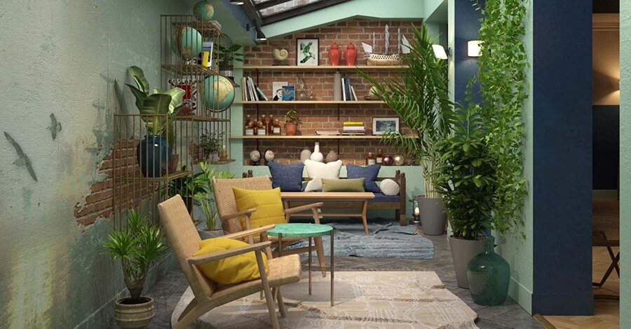 Phòng khách xanh lá cây với ghế mây, cây xanh và kệ sách tường gạch.