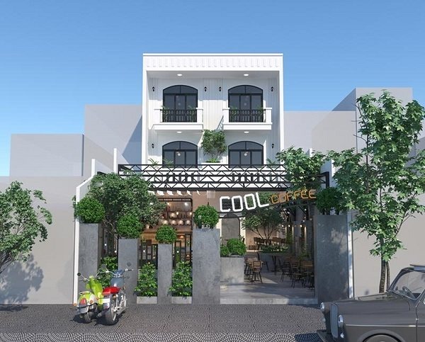 Quán cà phê hiện đại với tông màu trắng, thiết kế ba tầng, mặt tiền trang trí cây xanh và xe máy phía trước.