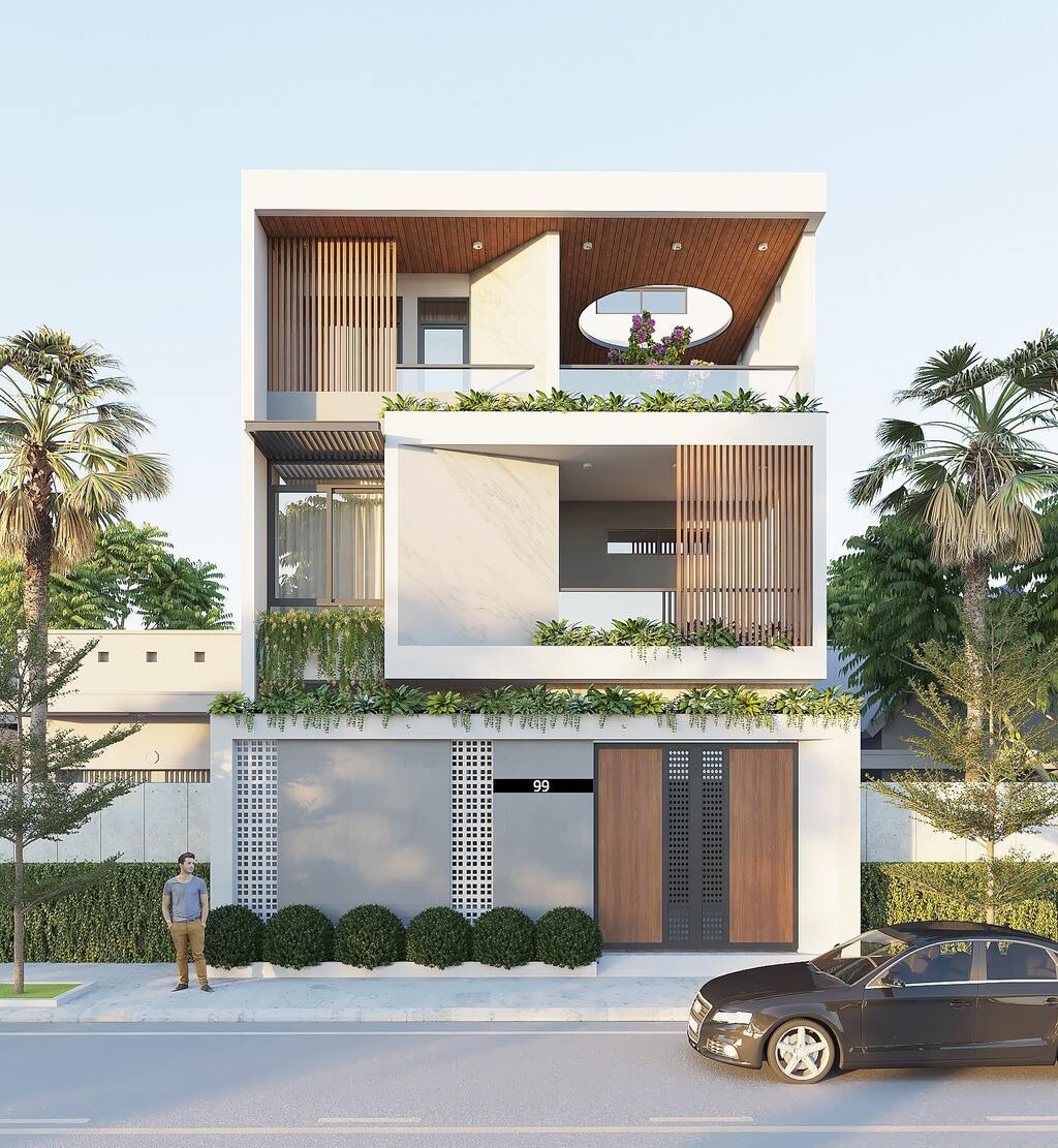 Nhà phố hiện đại ba tầng với ban công và cây xanh phía trước, xe hơi đậu phía trước, dưới bầu trời trong xanh.