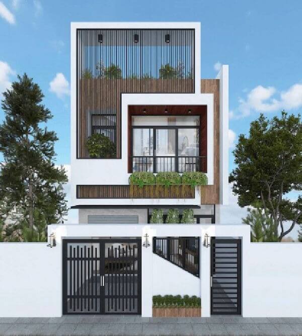 Nhà phố hiện đại, thiết kế tối giản với nhiều cây xanh, mặt tiền thoáng đãng, cửa sắt đen, tường trắng.