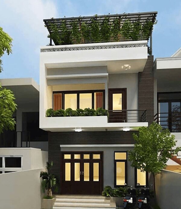 Nhà phố hiện đại 2 tầng với ban công, cây xanh và cửa kính lớn, thiết kế sang trọng, kiến trúc đương đại.
