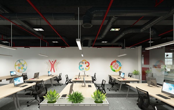 Văn phòng hiện đại với bàn làm việc, máy tính và cây xanh, trang trí tường với hình vẽ sáng tạo.