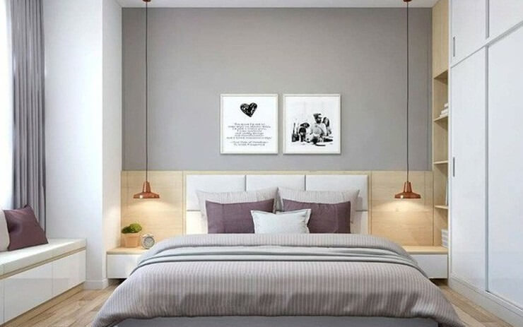 Phòng ngủ hiện đại với tông màu xám, giường đôi, đèn treo, tranh treo tường và tủ quần áo trắng.