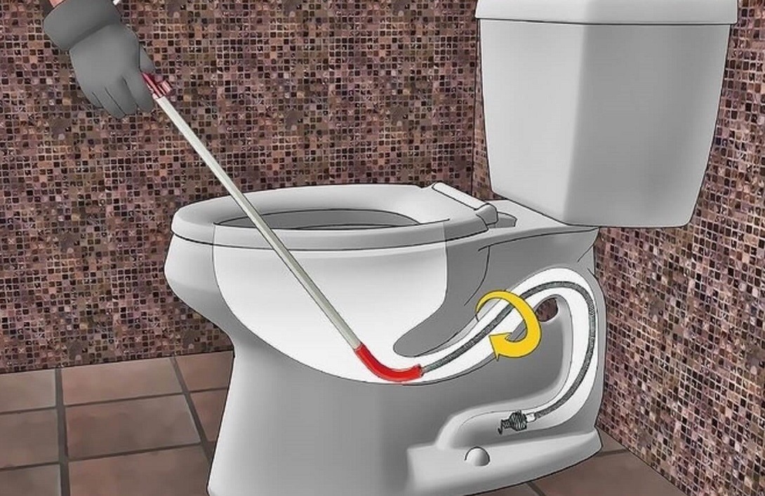 Sơ đồ hướng dẫn thông tắc bồn cầu bằng móc kim loại, có mũi tên chỉ vị trí cần xử lý.