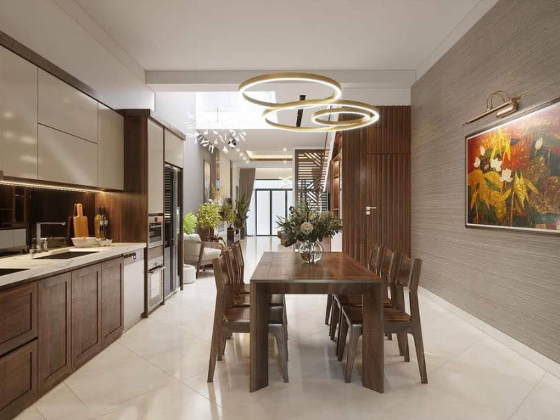 Phòng ăn hiện đại có nội thất gỗ, đèn trần lạ mắt và bức tranh nghệ thuật treo tường.