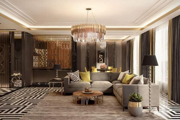 phong-cach-thiet-ke-van-phong-nghe-thuat-art-decor Phòng khách sang trọng với sofa xám, đèn chùm lớn và trang trí nội thất hiện đại.