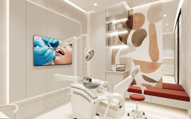 Phòng khám nha khoa hiện đại với ghế khám, trang thiết bị tiên tiến và trang trí nghệ thuật trên tường.