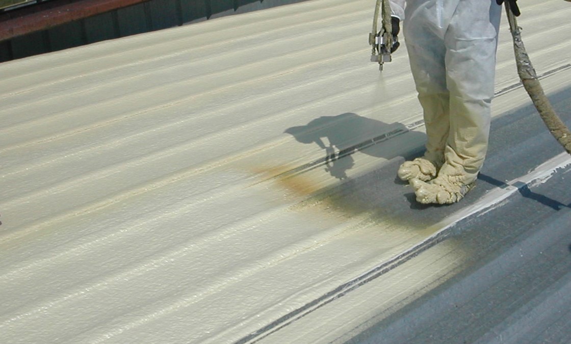 phun-foam-pu-chong-nong-cho-mai-ton Công nhân phun sơn bảo vệ mái tôn cách nhiệt, tăng độ bền và chống thấm nước.