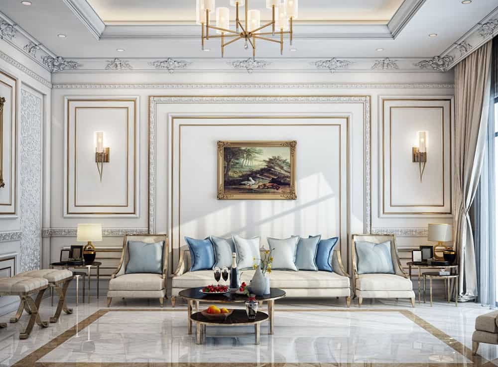 Phòng khách sang trọng với sofa trắng, gối xanh, đèn treo trần và bức tranh trang trí trên tường.