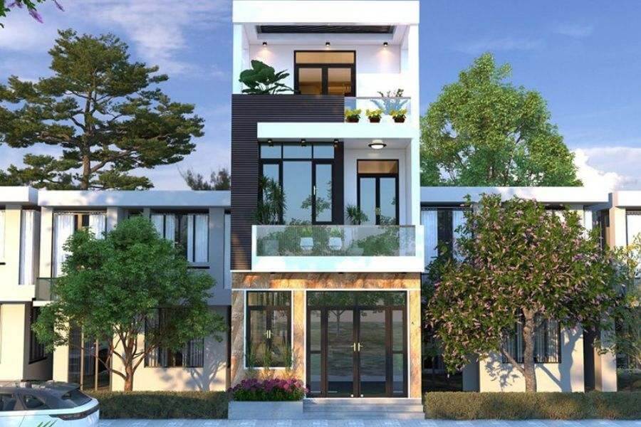 Nhà phố hiện đại 3 tầng với cửa kính lớn, ban công và nhiều cây xanh xung quanh, bầu trời trong xanh.