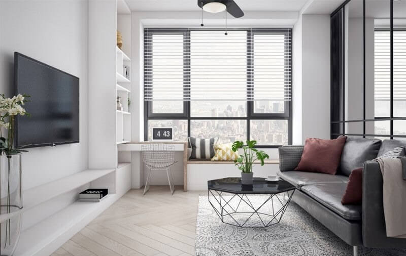 Phòng khách hiện đại với sofa đen, bàn kính và cửa sổ lớn nhìn ra thành phố.