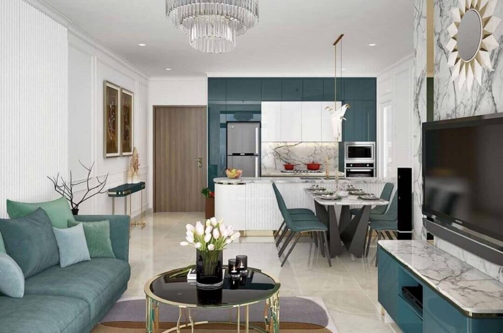 Phòng khách hiện đại với sofa xanh, bàn trà, nhà bếp mở, trang trí sang trọng và đèn chùm.